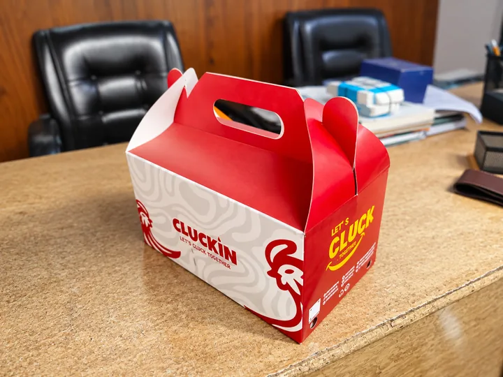 Cluckin’ branded takeaway box viewed from above