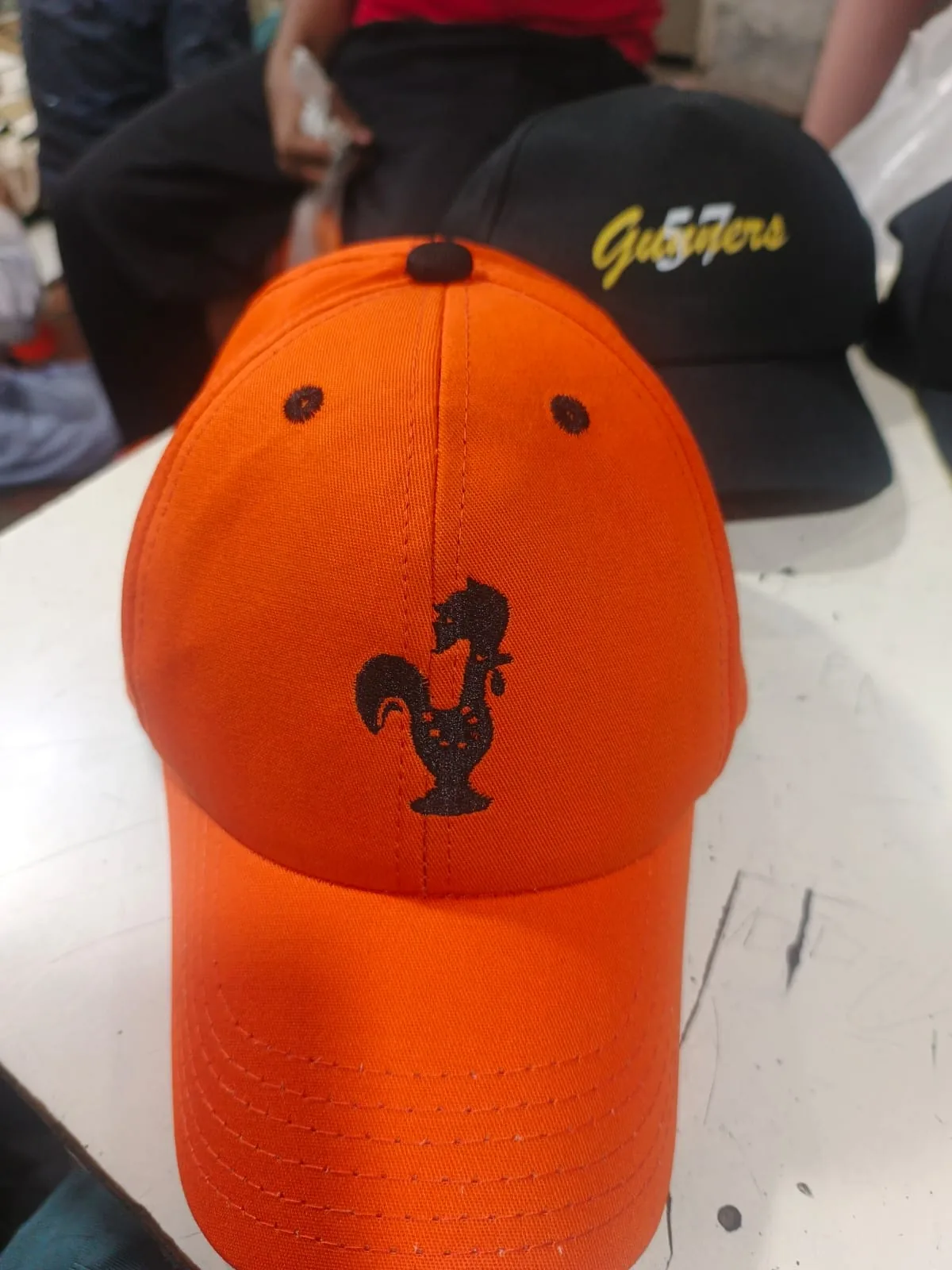 Orange cap with Peri-Peri Guys mascot mark